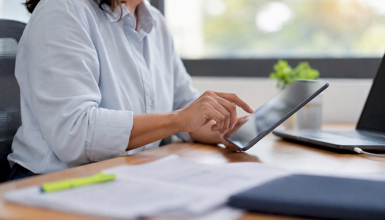 Payroll analyst's hands navigating payroll data